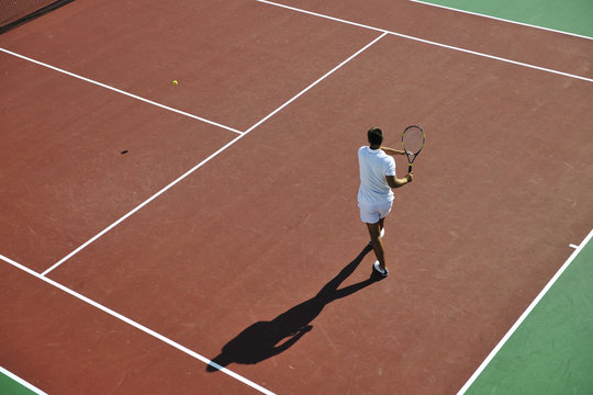 young man play tennis outdoor