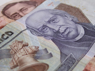 Close up of two mexican currency bills.