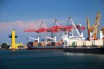 The trading seaport with cranes, cargoes and ship