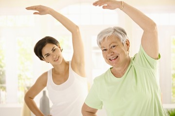 Elderly woman with personal fitness trainer