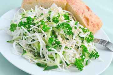 Salad of fresh cabbage and cucumber with herbs and sesame