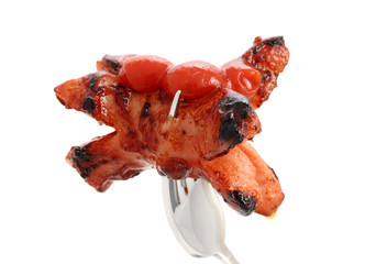 Grilled sausage with ketchup on fork.