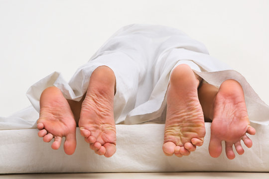 Feet of couple making love
