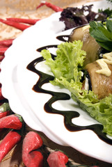 Appetizer made of rolled egg-plants served with salad