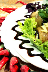Appetizer made of rolled egg-plants served with salad