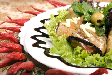 Appetizer made of rolled egg-plants served with salad