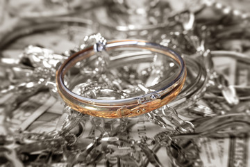 Golden bracelet and jewelry at money background