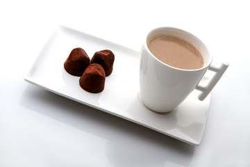 cup of coffee with cinnamon on a white background.