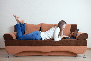 woman with laptop on the sofa