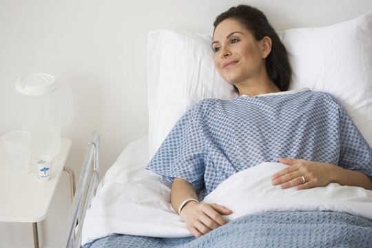 Hispanic woman laying in hospital bed
