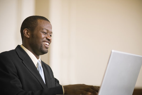 African businessman typing on laptop