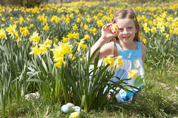 Girl On Easter Egg Hunt In Daffodil Field