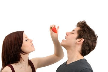 young beautiful couple with a strawberry (white background)