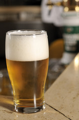 Glass of beer in pub close up