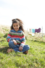 Fototapeta premium Young Girl Sitting Outside In Caravan Park