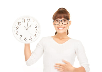 woman holding big clock