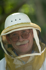 man beekeeper in hat with net
