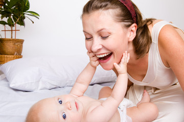 Obraz na płótnie Canvas Cheerful woman with baby