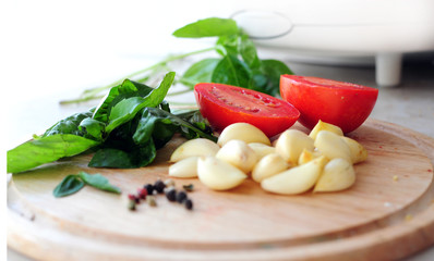 Vegetables on chopping board - focus on tomatoes