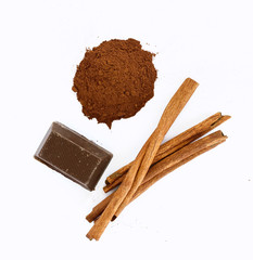 chocolate, cinnamon sticks and cocoa on white