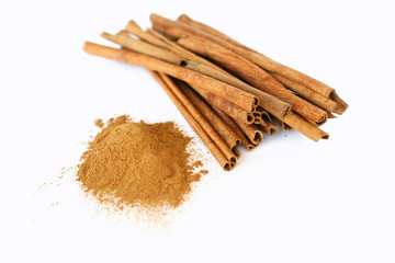 cinnamon sticks and powder on white background