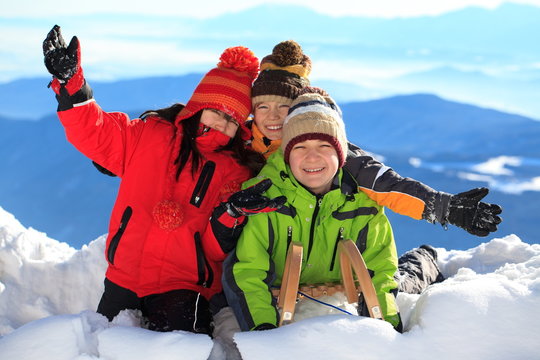 Happy children in snowy Alps