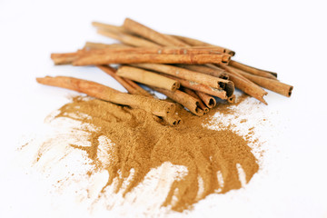 cinnamon sticks and powder on white background