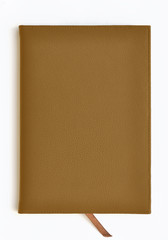 Light brown leather notebook on white background