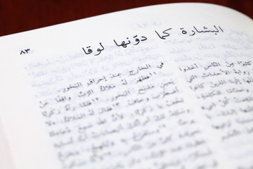 Fototapeta premium Arabic Bible open to the Gospel of Luke. Shallow dof