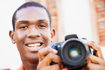 African man holding digital camera