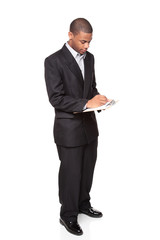 writing on clipboard - African American businessman