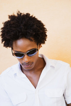 African man wearing sunglasses and looking down