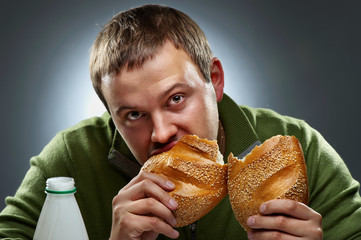 Hungry man with mouth full of bread