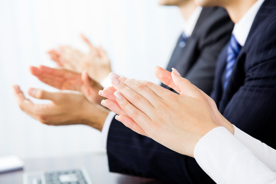 Close Up Clapping Hands Of Businesspeople At Presentation