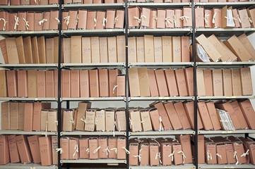 Office archive with many folders on metal shelves