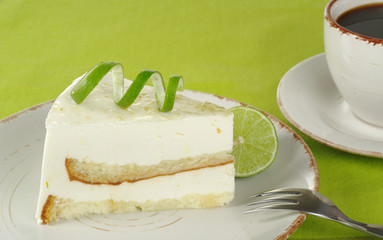 Lime cake with coffee on green (Selective Focus)