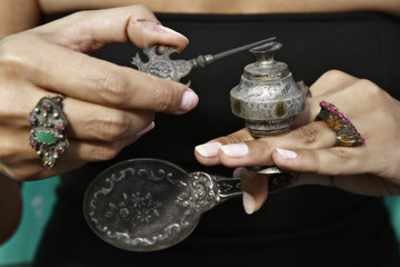 woman holding an antique Middle Eastern make-up bottle