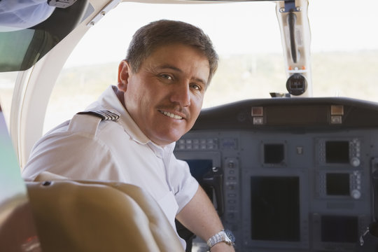 Hispanic pilot in cockpit