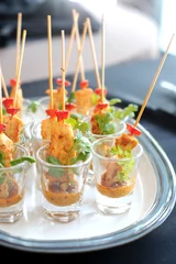 Poster Delicious chicken satay skewers served in a glass © Isaxar