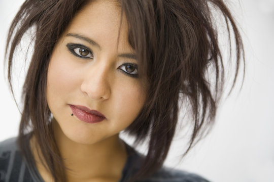 Hispanic teenage girl with wild hairstyle