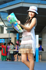Little Chinese Asian Tourist Girl using her map