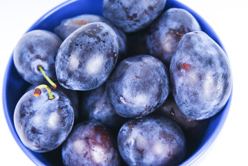 dark blue plums in the bowl