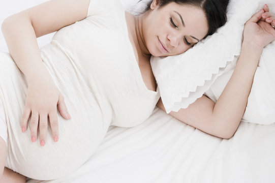 Pregnant Hispanic woman sleeping