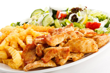 Grilled meat, French fries and vegetables