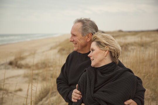 Caucasian couple standing on beach