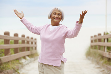 Senior African American woman with arms outstretched