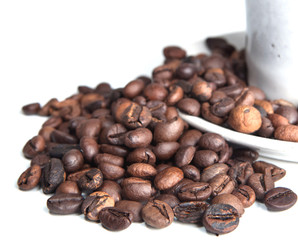 Coffee beans and cup isolated over white.