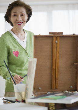 Japanese woman painting on easel