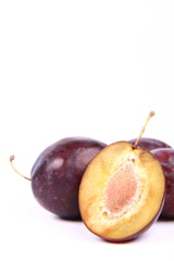 Plums on white background with space for text