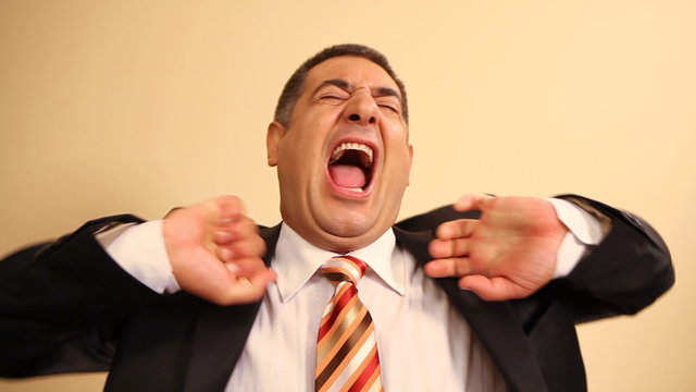 Tired businessman yawning and stretching - Exhausted